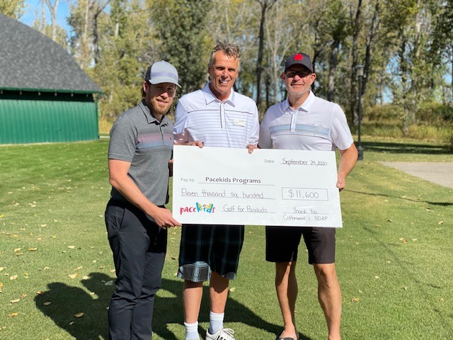 Board Members & Executive Director holding cheque for Golf for Pacekids