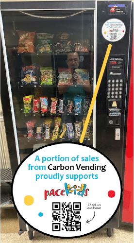Photo of a vending machine full of snacks, with a Pacekids sticker on it.