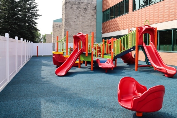Accessible children’s playground with slides and climbing equipment.