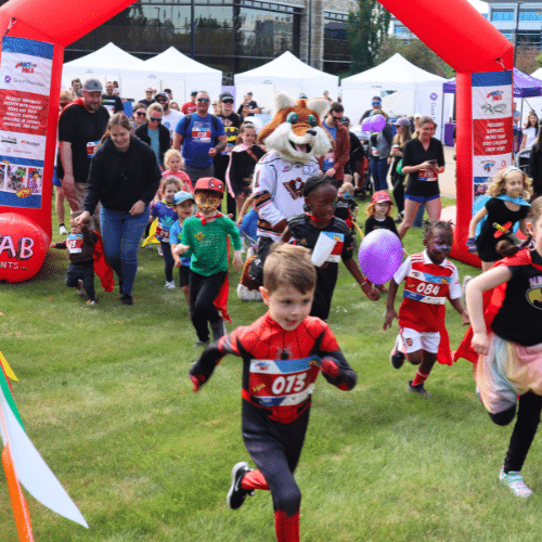 Children running at the start line of a race